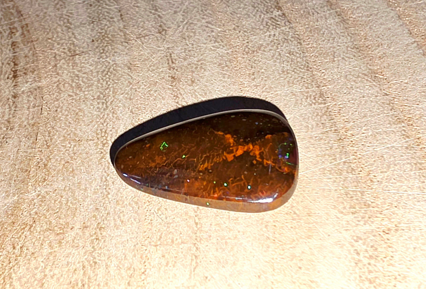 Brown stone with a glossy surface on a beige textured background