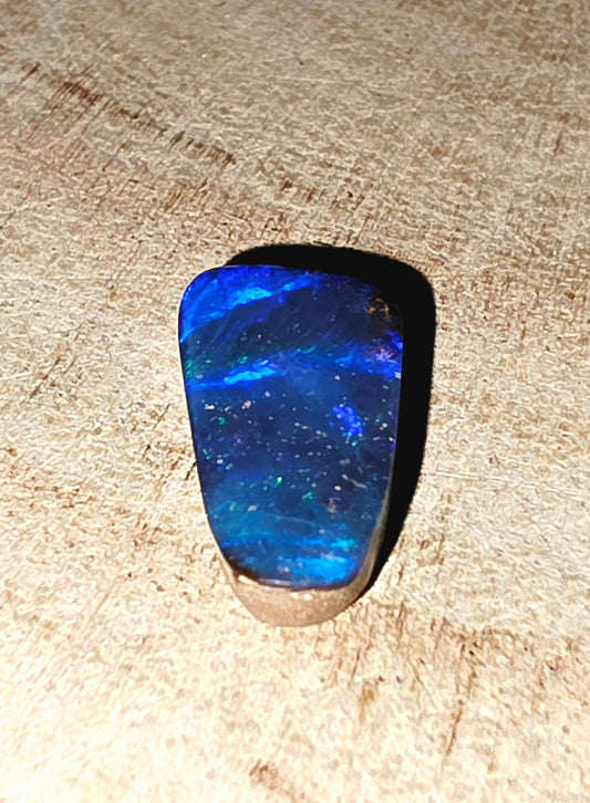 Blue stone on a textured beige surface