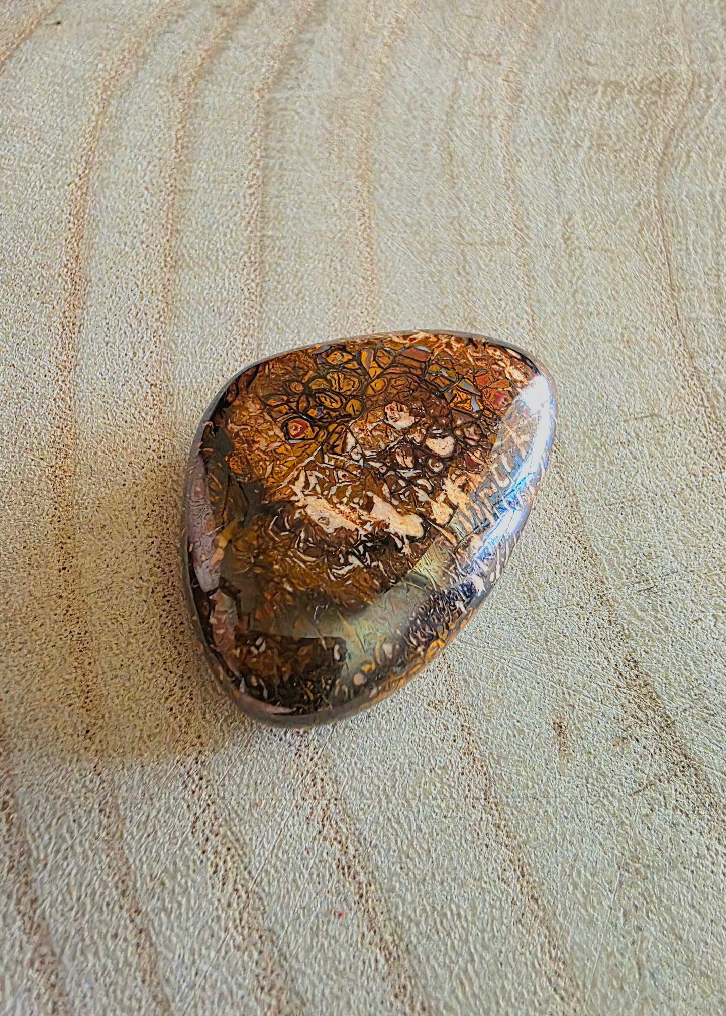 Decorative stone with intricate patterns on a textured surface