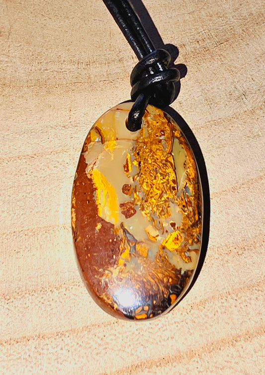 Oval-shaped opal pendant on a beige background