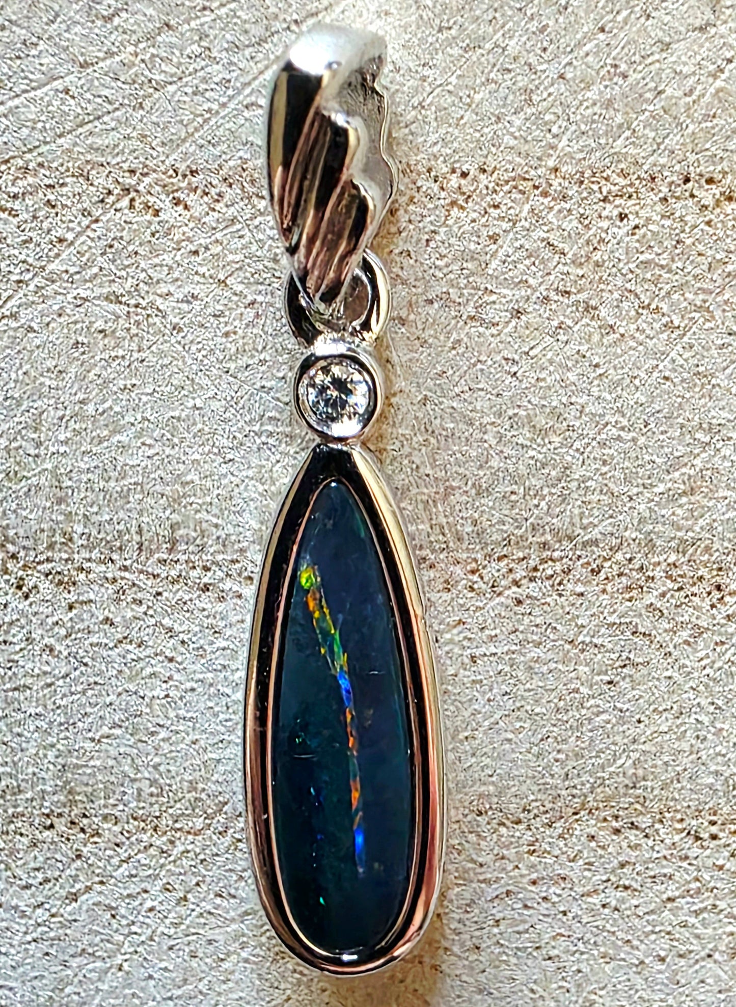 Opal pendant on a textured surface