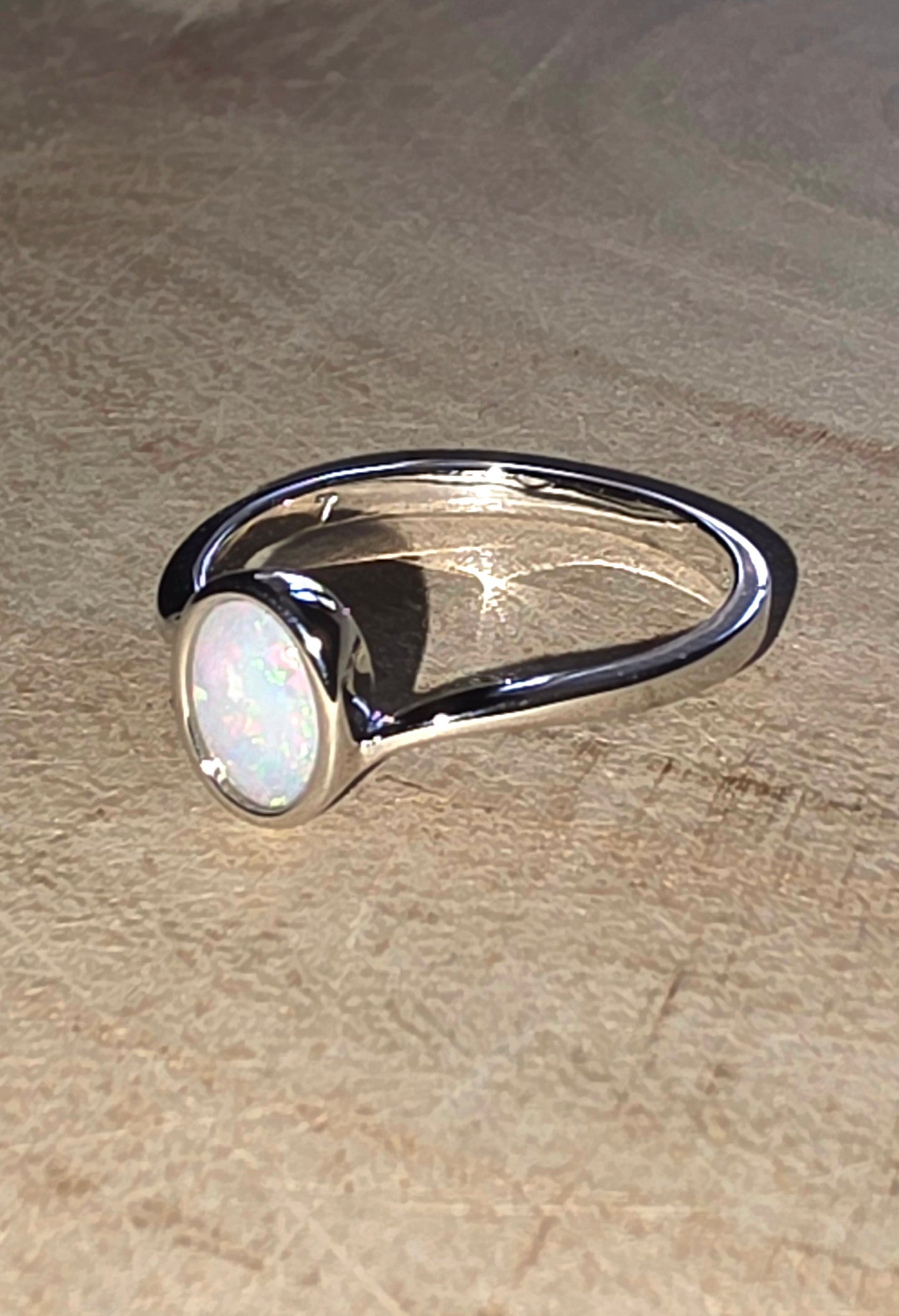 Opal ring on wood surface
