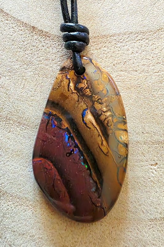 Pendant necklace opal stone on a beige background
