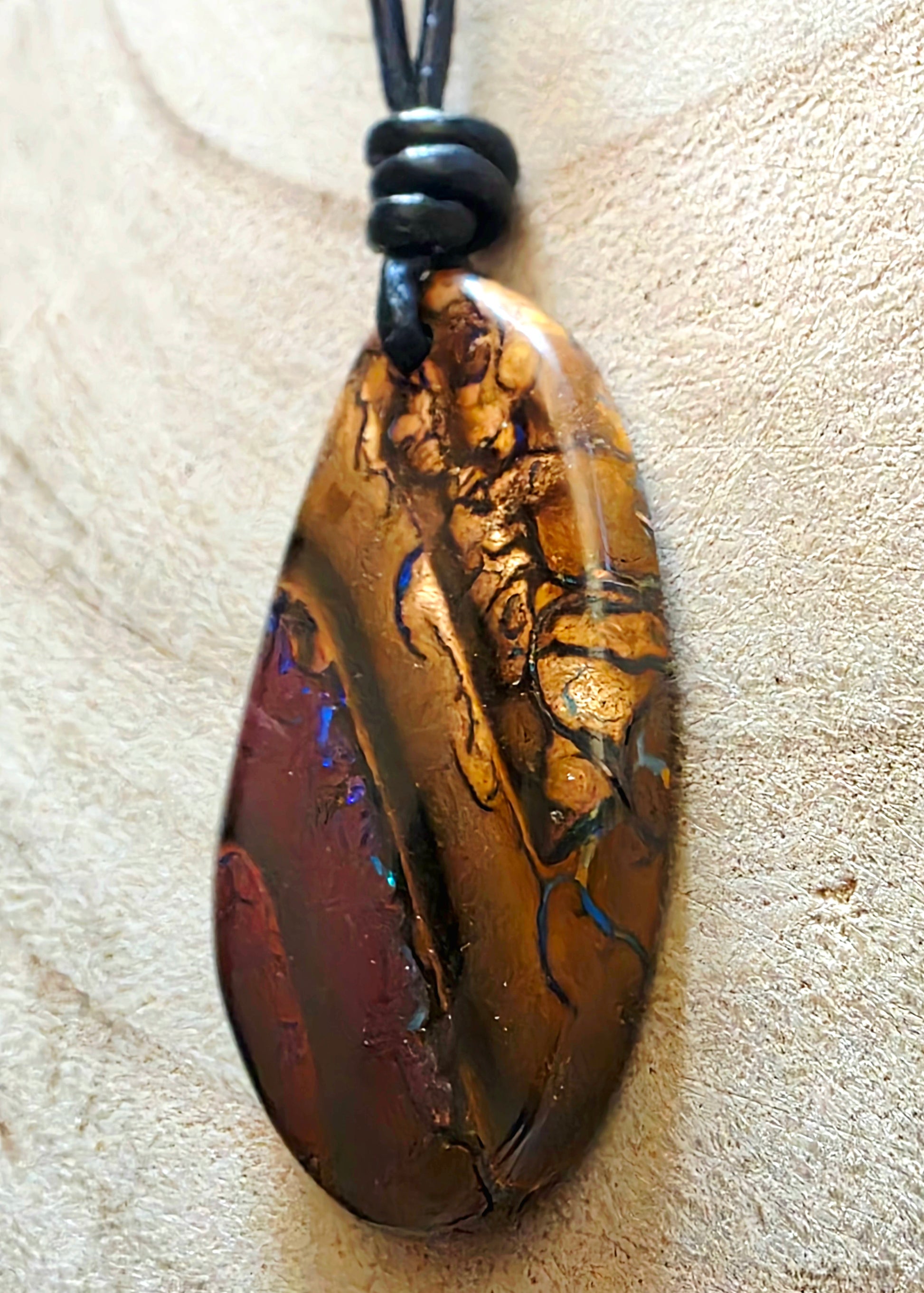 Multicoloured pendant on a beige background