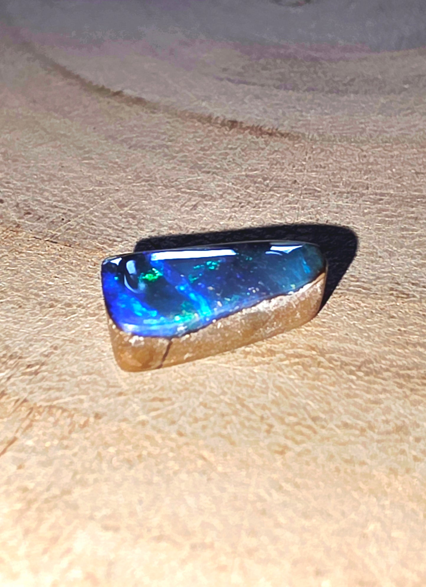Blue gemstone on a beige surface