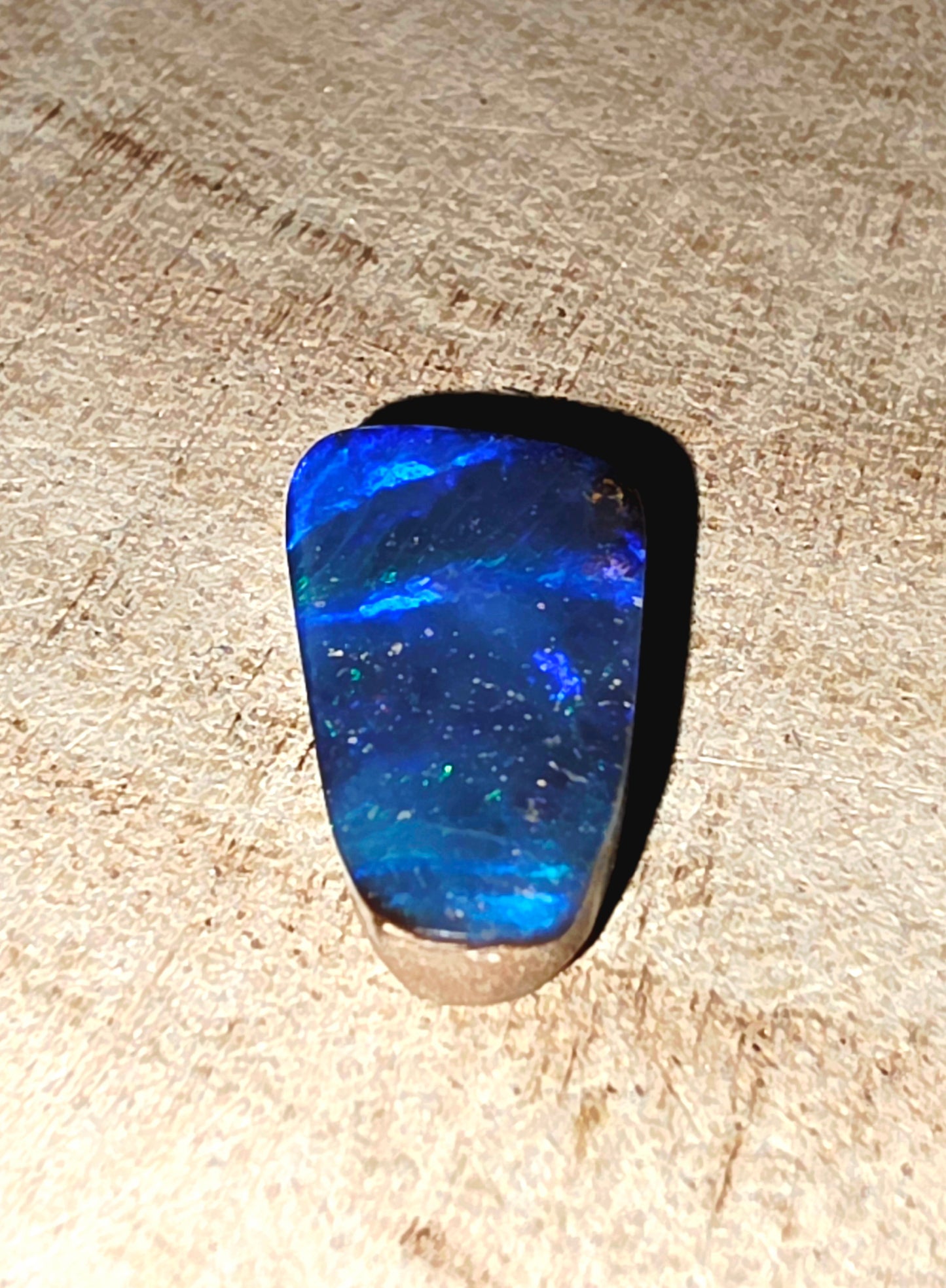 Blue stone on a textured beige surface