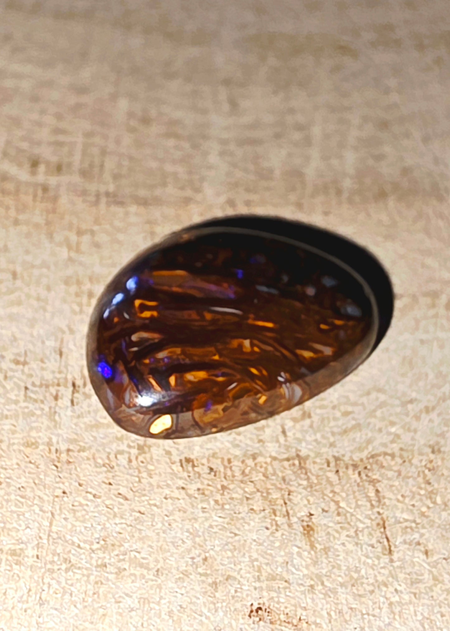 Brown opal on a beige fabric background
