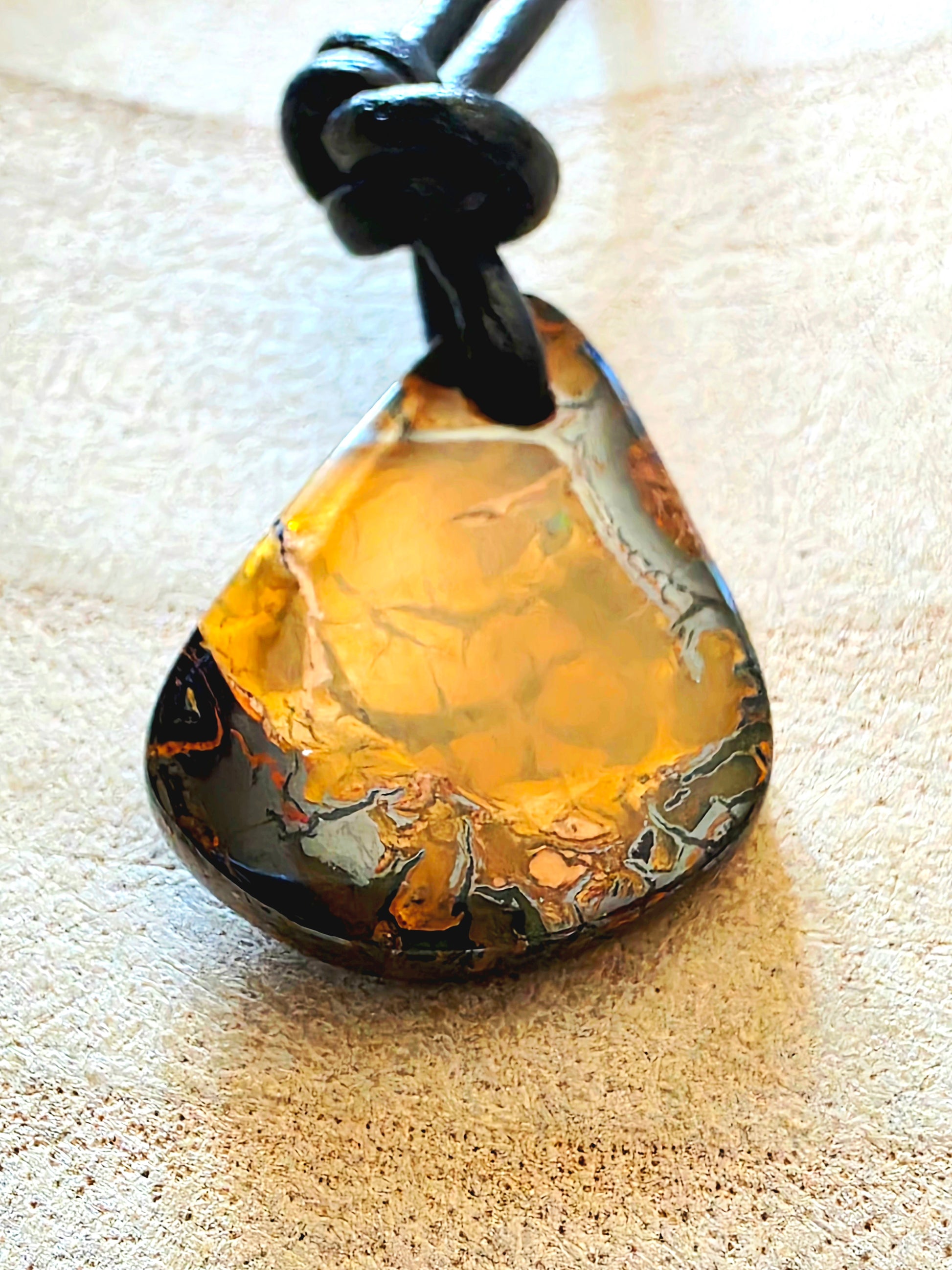 Opal pendant on a beige surface