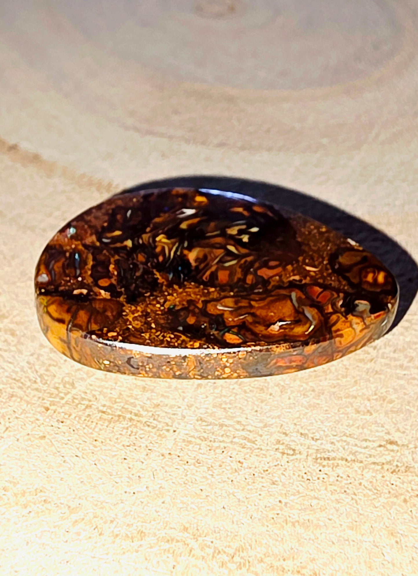 Brown and gold decorative stone on a beige surface