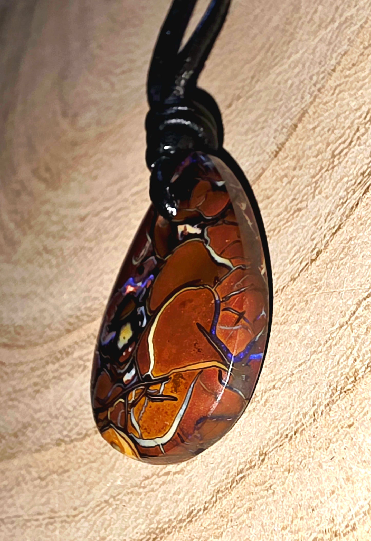 Teardrop Boulder Opal Necklace – Purple Tribal Pattern on beige background