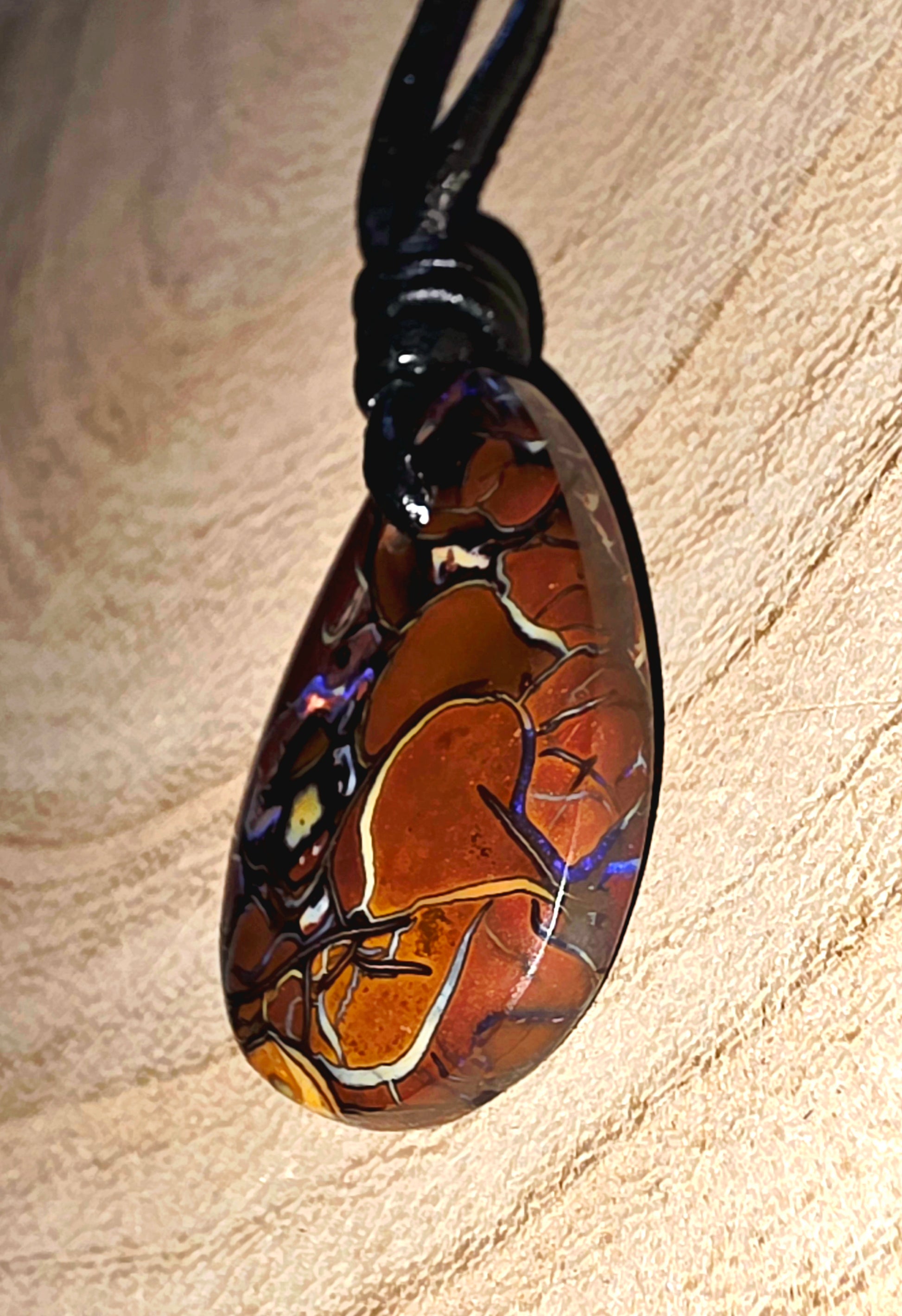 Teardrop Boulder Opal Necklace – Purple Tribal Pattern on beige background