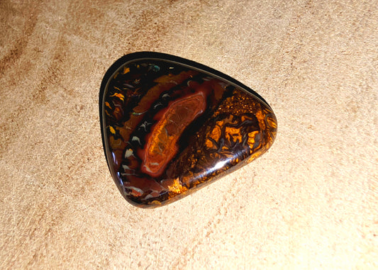 Tortoiseshell shell opal pattern on a beige surface