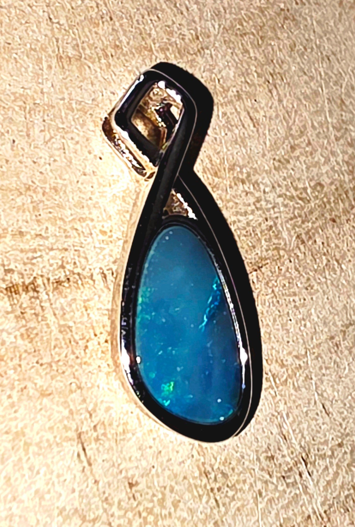 Boulder Opal Pendant - Electric Blue & Green Flash in Crossed 925 Silver Mount shown from the side