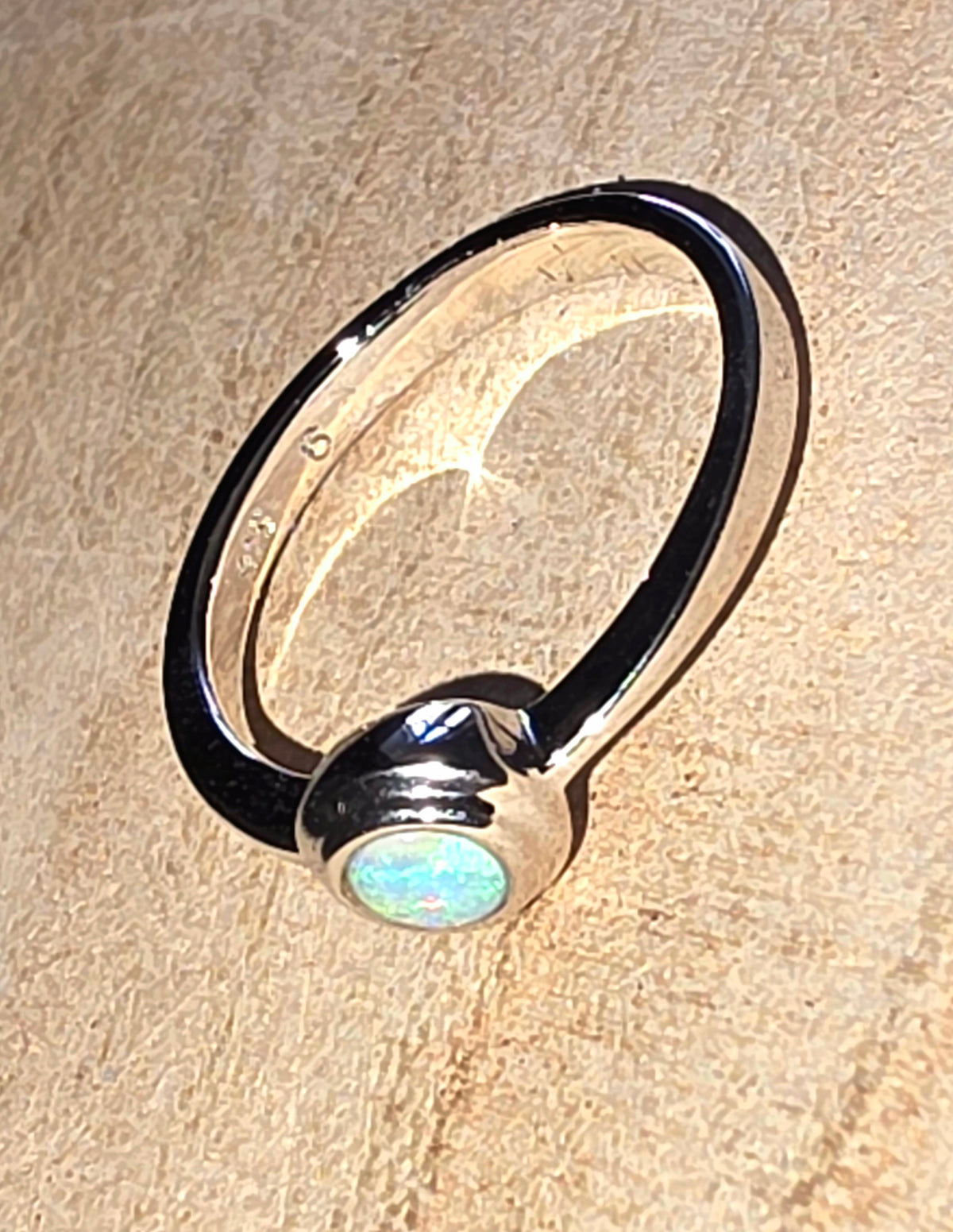 A 925 silver stacker ring with a crystal opal