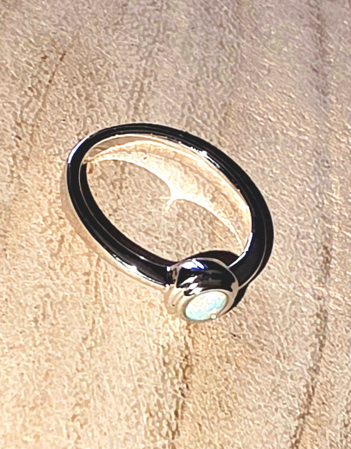 A 925 silver stacker ring with a crystal opal